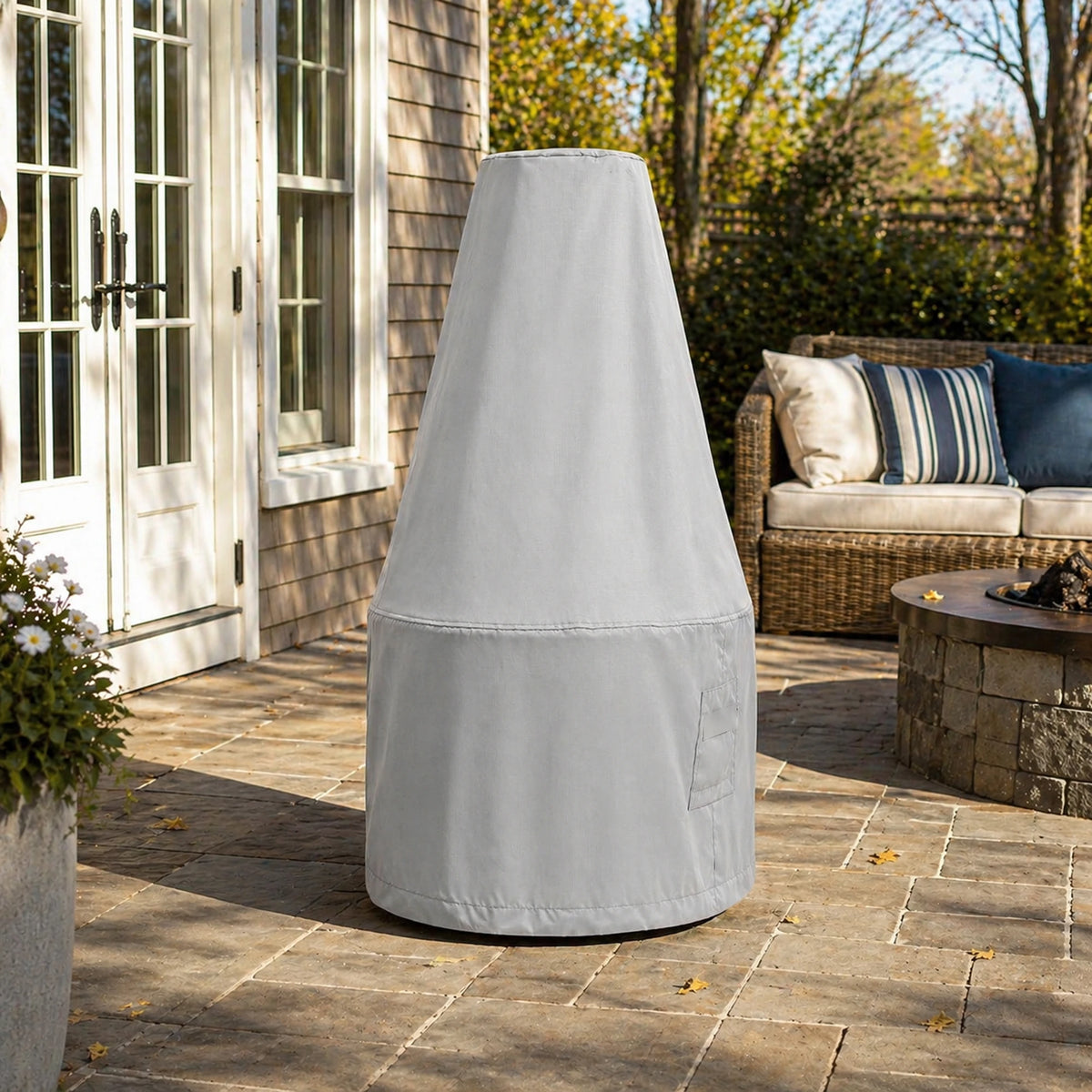 Custom Antique Bronze Chiminea Cover in light gray, shown outdoors on a stone patio