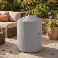Custom Classic Chiminea Cover in light gray, shown on a stone patio next to outdoor lounge seating and garden landscaping