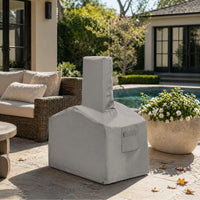 Custom Modern Geometric Chiminea Cover in light gray, shown on a luxury patio with pool, lounge seating, and flowering plants