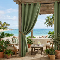 Olive green custom Sunbrella outdoor curtains hung on a coastal wood pergola with grommet top, tropical palm trees and ocean in background