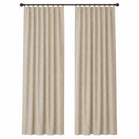 A pair of beige textured curtain panels hanging from a black rod over a window in a neutral room setting.