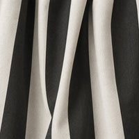 A close-up of draped fabric with bold vertical black and off-white stripes, showing the material texture and folds.