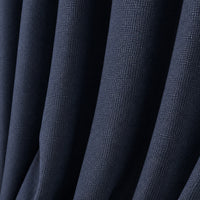 A close-up of dark navy blue textured fabric with soft vertical folds.