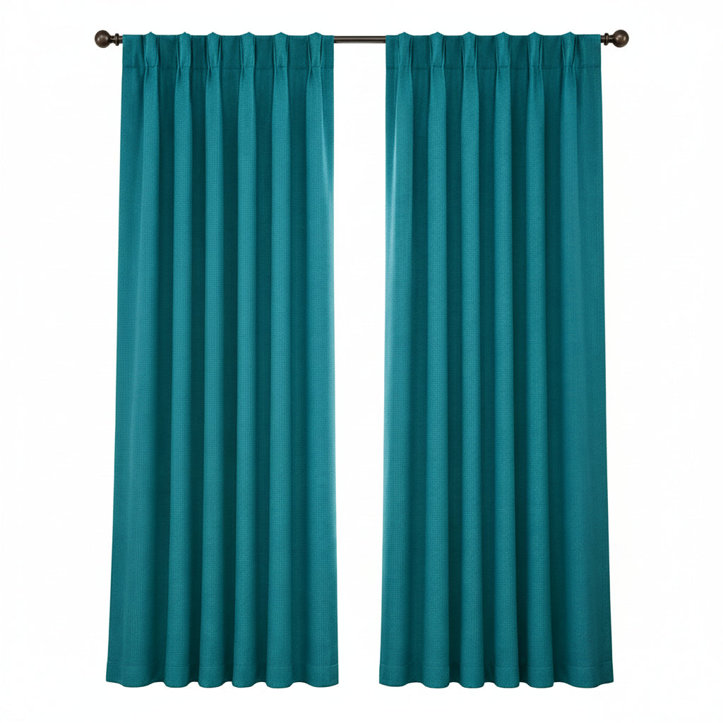 A pair of teal window curtain panels hanging on a dark rod in a bright room with a window, side table, framed art, and part of a sofa visible.