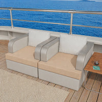 Outdoor seating area with cushions on a deck overlooking the ocean.